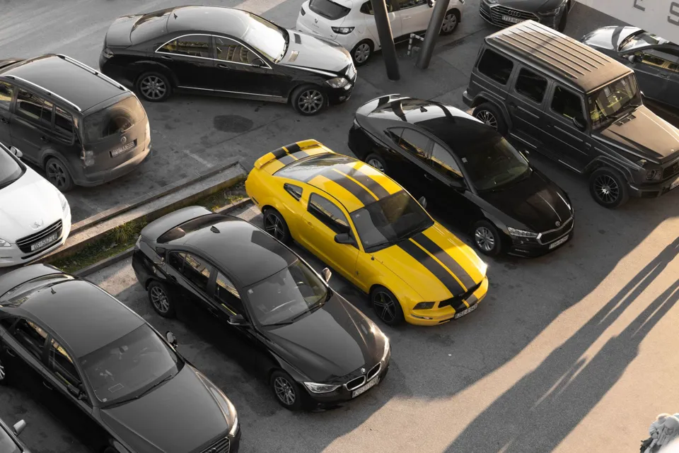 eine Gruppe von Autos, die auf einem Parkplatz geparkt sind