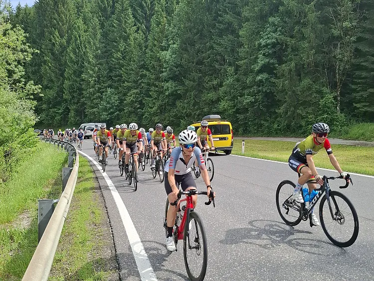 eine Gruppe von Menschen, die auf einer Straße Fahrrad fahren